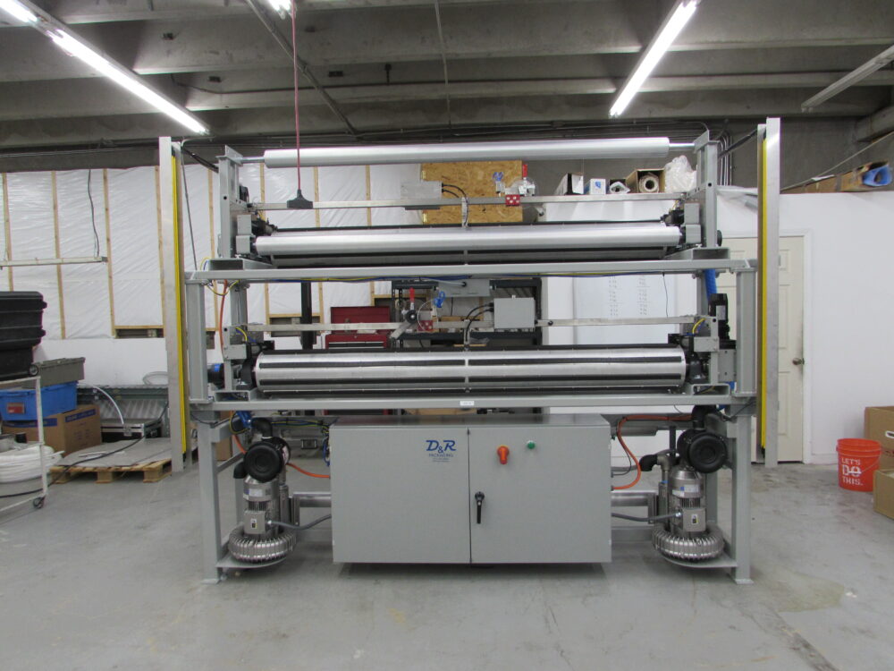 end of row tape application machine designed by D&R packaging for large rolls of film, plastic wrap, or cling wrap